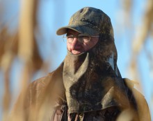 Hunter through corn stalks